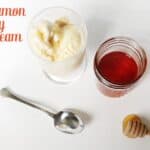 A glass of Cinnamon Honey Ice Cream, a jar of honey with lid, a honey dipper, and a spoon rest on a white surface. Text reads "cinnamon honey ice cream.