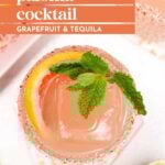 Overhead view of a Paloma Cocktail garnished with a grapefruit slice and mint, served in a glass with a salted rim. Text overlay reads “paloma cocktail grapefruit & tequila.”.