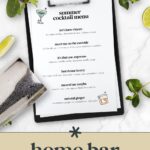 A clipboard with a summer cocktail menu surrounded by limes, a shaker, and a salt-rimmed glass—perfect inspiration for crafting a home cocktail menu.