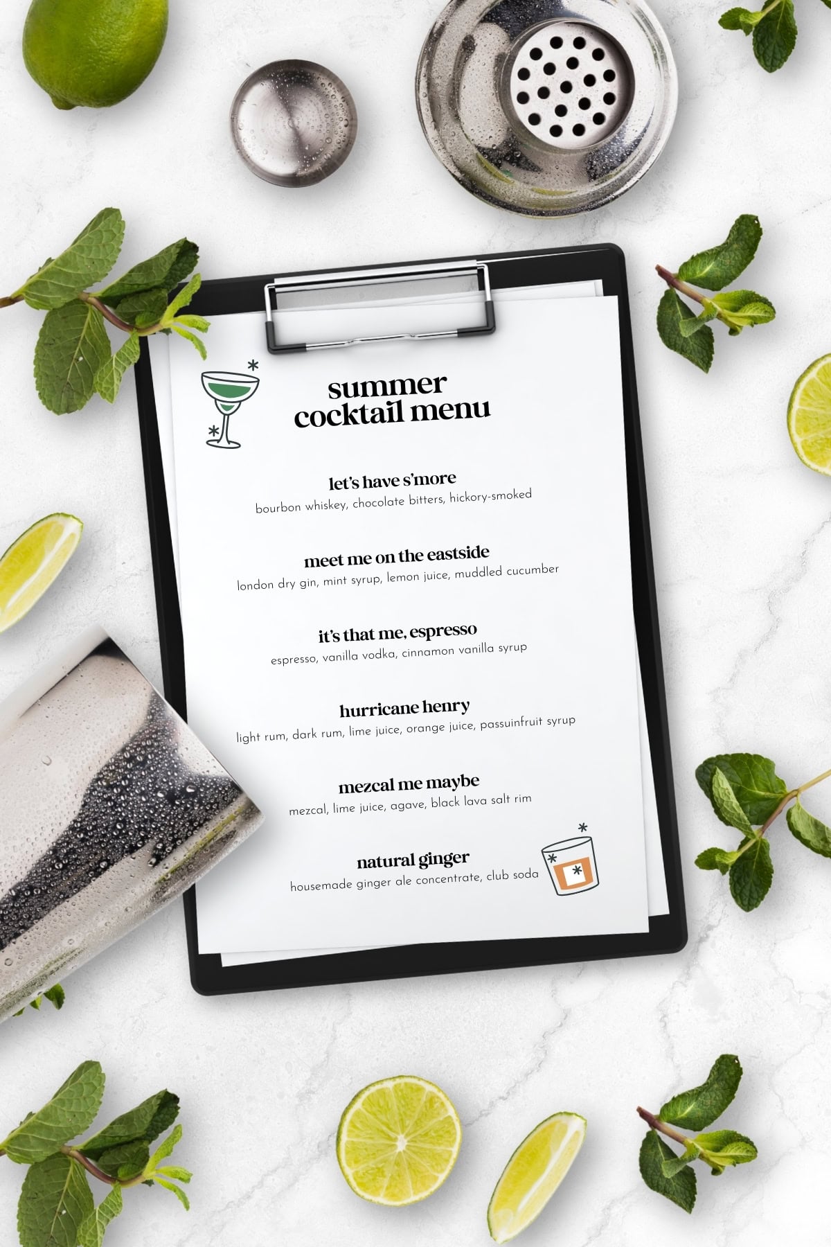 Clipboard with a summer cocktail menu, surrounded by mint, lime slices, a drink, and a cocktail strainer—perfect inspiration for crafting a home cocktail menu.