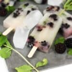 Soak up the sun and rum with a batch of Blackberry Mojito Popsicles. They're a boozy, zesty, frozen treat starring fresh blackberries, lime, mint and rum.&nbsp;(via feastandwest.com)