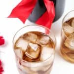 two black Russian cocktails on a white background with a bottle of coffee liqueur