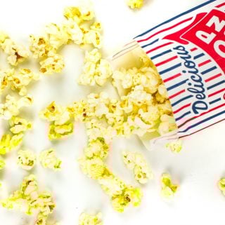 movie theatre butter popcorn spilling out of a popcorn bag