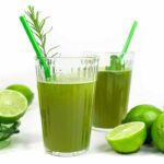 two glasses of herbal limeade with green straws and limes