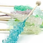 colorful rock candy swizzle sticks on a white background
