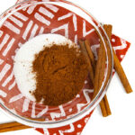 a bowl of cinnamon and sugar that is ready to be combined to make homemade cinnamon sugar