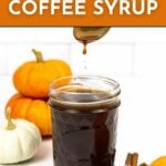 A jar of pumpkin spice syrup is shown with syrup dripping from a spoon above it, surrounded by small pumpkins. Text reads: "Pumpkin Coffee Syrup. Get the recipe. FEASTANDWEST.COM.