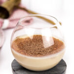 a closeup of cape velvet liqueur in a brandy snifter on a black marble coaster
