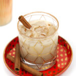 a closeup of a pumpkin spice White Russian garnished with a cinnamon stick