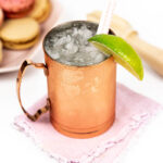 closeup of crushed ice in a french mule with a lime garnish