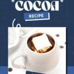 A white mug filled with instant pot hot chocolate, topped with a large marshmallow, sits surrounded by a blue graphic featuring the text "Hot Cocoa Recipe.