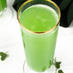 bubbles on top of a green mimosa cocktail
