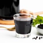 a shot glass with elderberry syrup