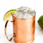 a Moscow mule with a lime garnish in a copper mug