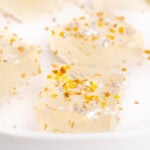closeup of edible gold and silver stars on jello shots