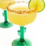a margarita glass garnished with a lime wheel