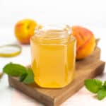 a jar of peach syrup