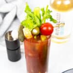 a non-alcoholic Bloody Mary with olives, tomatoes, cheese and celery on top