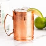 a mule cocktail with a bottle of zero-proof spirits
