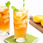 two arnold palmers and a cutting board with lemons