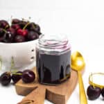 a bowl of cherries with cherry syrup