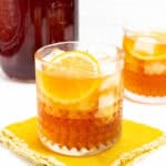 a glass of iced tea on a napkin next to a pitcher