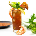 a plate of Bloody Mary salt with a rum Bloody Mary.