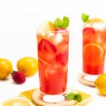 mint leaves, strawberries and lemon slices garnishing a glass of strawberry lemonade