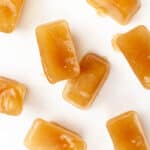 tea ice cubes scattered around a white background