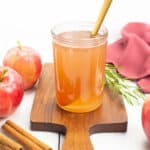 apple simple syrup with its ingredients on a white background