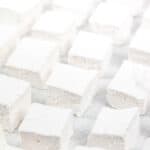 DIY white fluffy marshmallow squares sit in rows on a white background