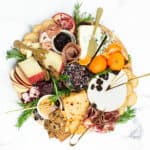 Overhead view of a Christmas Charcuterie Board resting on a white marble surface