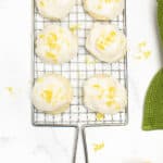 six lemon drop cookies on a cooling rack.