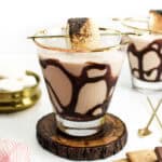 Two S'mores Martinis alongside graham crackers and chocolate squares.