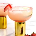 a Strawberry Margarita in a glass with a gold stem.