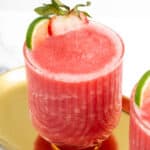 A close-up of a frozen strawberry daiquiri on a gold tray.