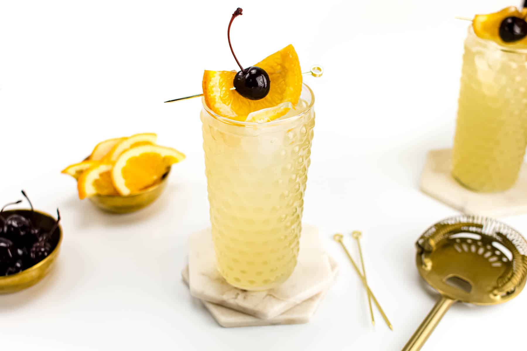 Classic cocktail with whiskey, lemon, and soda.