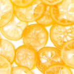 Sliced lemons on a white plate.