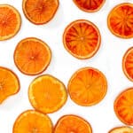 Sliced oranges on a white surface.