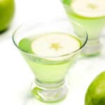 An Appletini - a glass of green liquid.