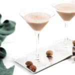 Two Brandy Alexanders with nutmeg on a tray.