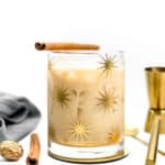 A glass of iced coffee with cinnamon sticks and a cinnamon stick.