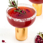 A flavorful pomegranate margarita infused with fragrant sprigs of rosemary.