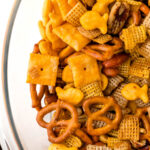 A bowl full of cheesy snack mix.