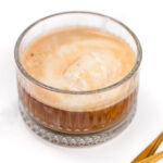 Two glasses of coffee with ice cream and spoons.