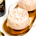 Two glasses of bailey's irish cream on a tray.