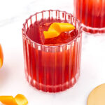 A boulevardier cocktail with a gold rim.