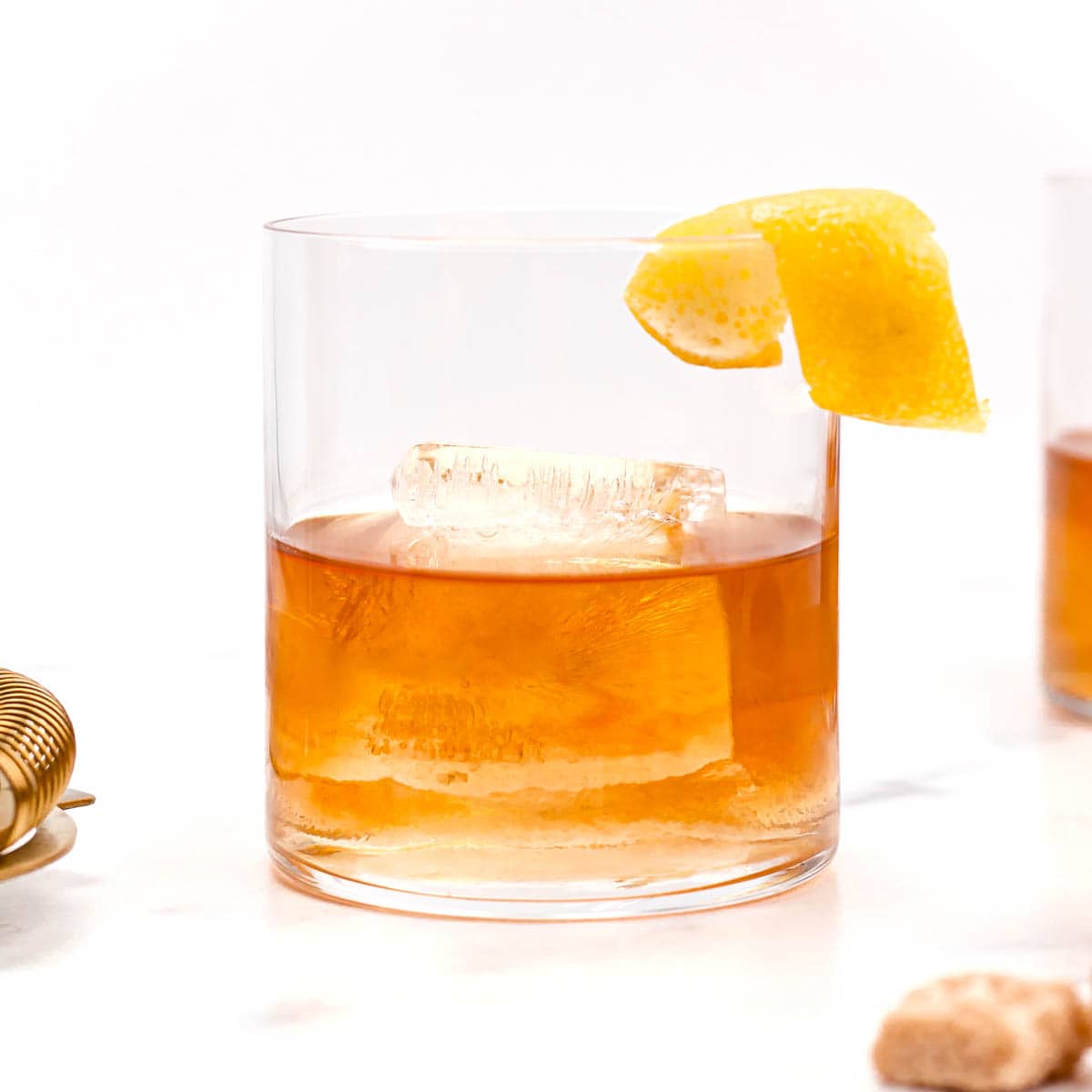 A Sazerac cocktail with a slice of orange.