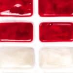 A row of red and white tiles on a white surface.