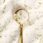 A gold spoon on top of a pile of margarita sugar.